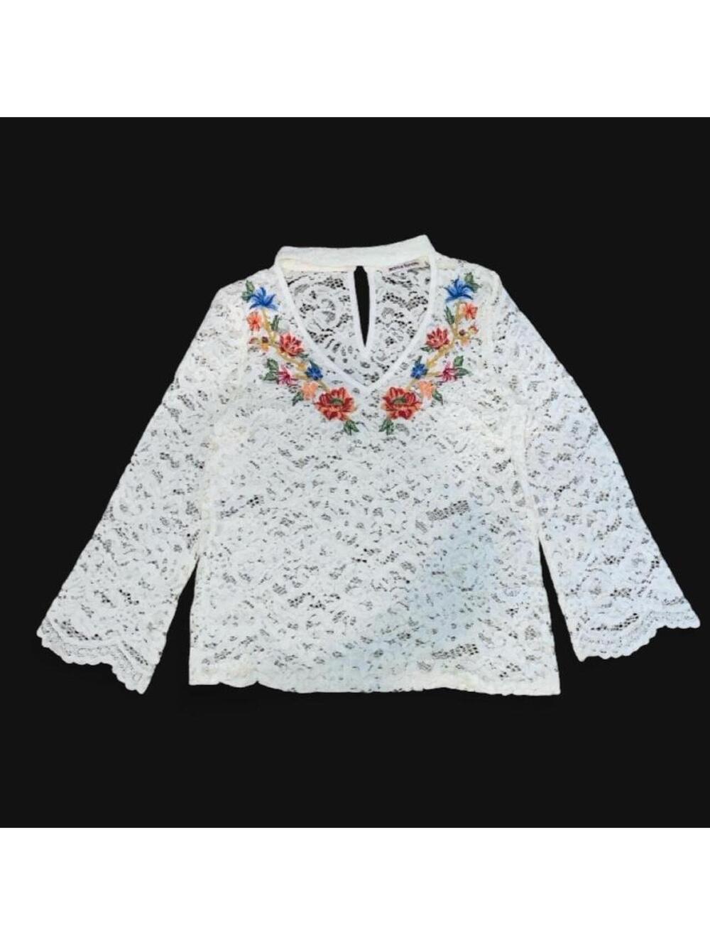White lace blouse with floral embroidery on the neckline